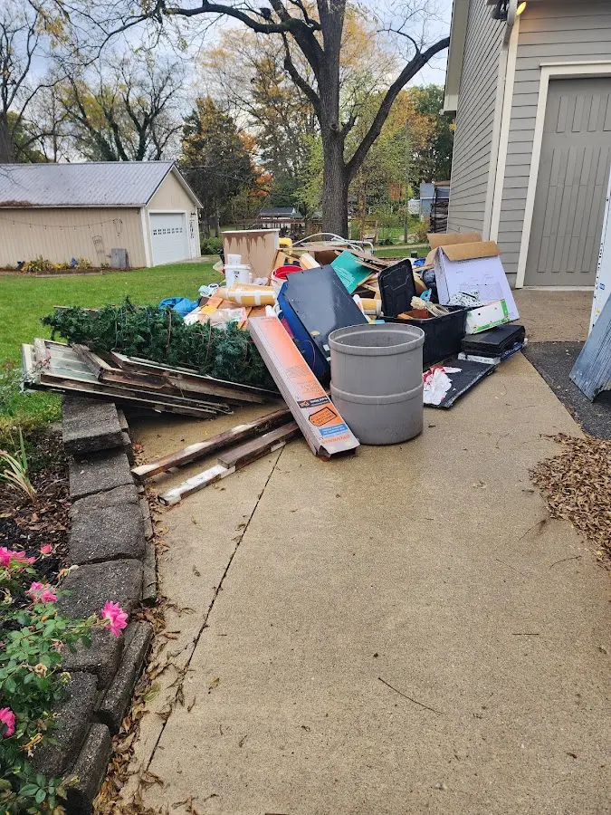 Dumpster being loaded with debris for Demolition Dumpster Rental in Sterling
